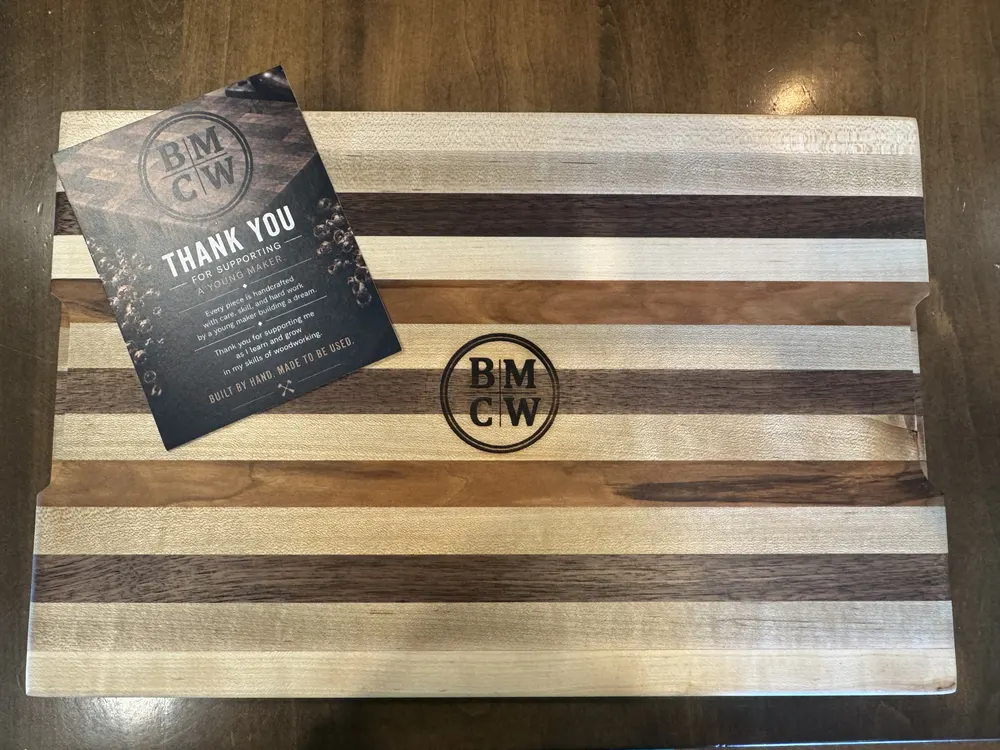 A finished striped board with the BMCW thank you card that ships with every piece