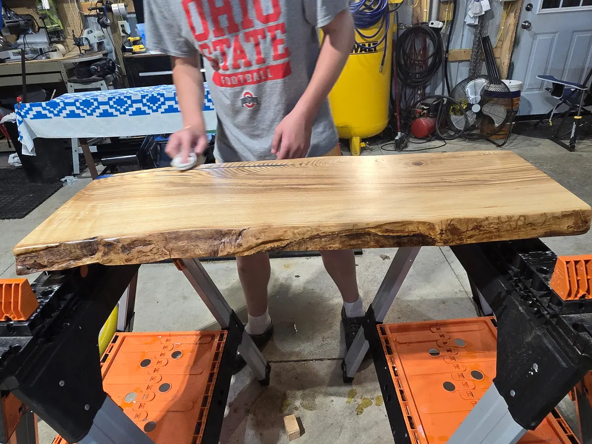 Brody hand-rubbing finish into a finished live edge slab